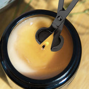Natural Living - Candle Care Tool Set - Black (2-Piece) — candle snuffer extinguishing a candle.