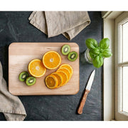 Natural Living - Maple Cutting Board — 30 x 20 cm maple cutting board used for fruit preparation.
