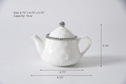 White teapot with silver lid and decorative band, shown with measurements on a light gray background.