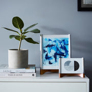 Nambé Sky View Photo Frame in a display setting; other items shown are sold separately.