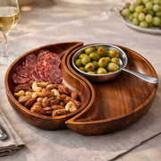 Nambé Yin Yang Chip & Dip in a display setting; other items shown are sold separately.