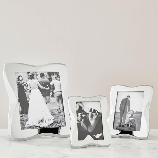 Nambé Bella Photo Frame in a display setting; other items shown are sold separately.