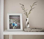 Nambé Braid Photo Frame in a display setting; other items shown are sold separately.