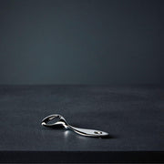 Nambé Twist Bottle Opener in a display setting; other items shown are sold separately.