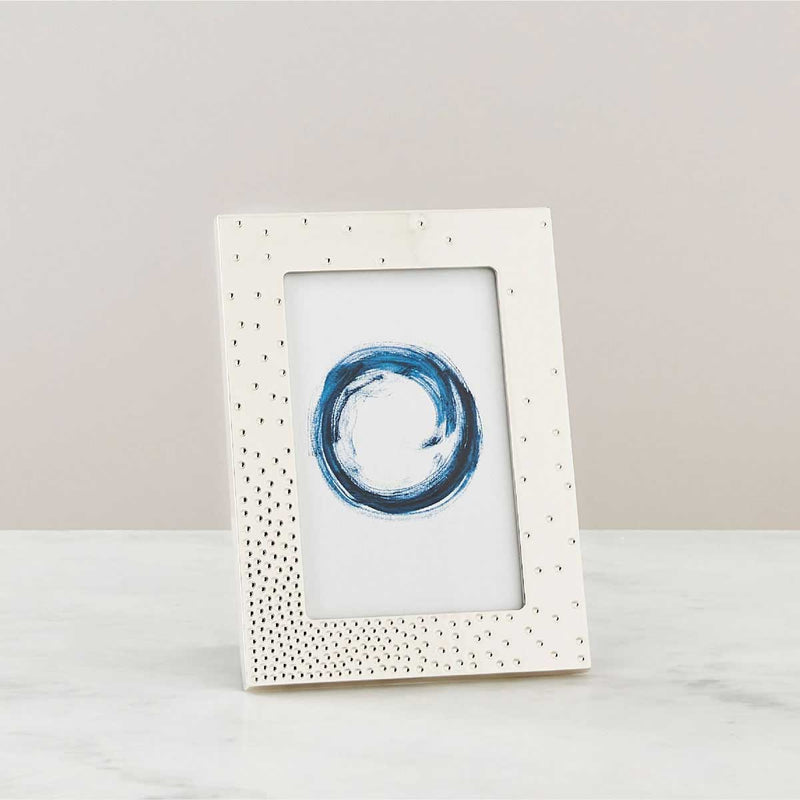 Nambé Dazzle Photo Frame in a display setting; other items shown are sold separately.