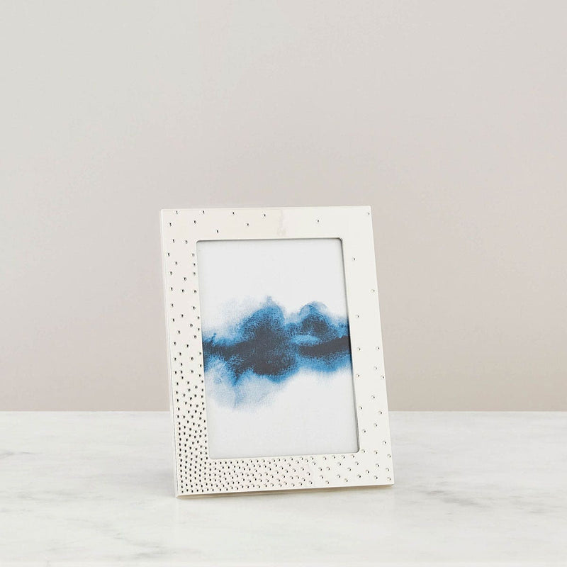 Nambé Dazzle Photo Frame in a display setting; other items shown are sold separately.