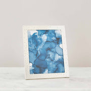 Nambé Dazzle Photo Frame in a display setting; other items shown are sold separately.