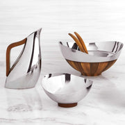 Nambé Pulse Pitcher in a display setting; other items shown are sold separately.