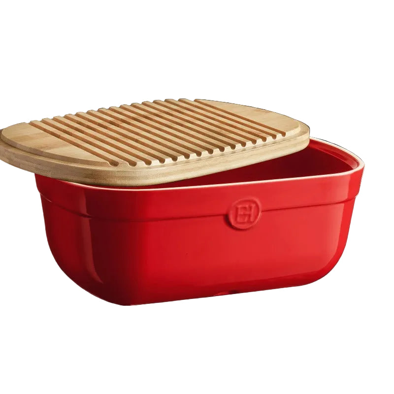 Red storage container with a wooden lid on a black background