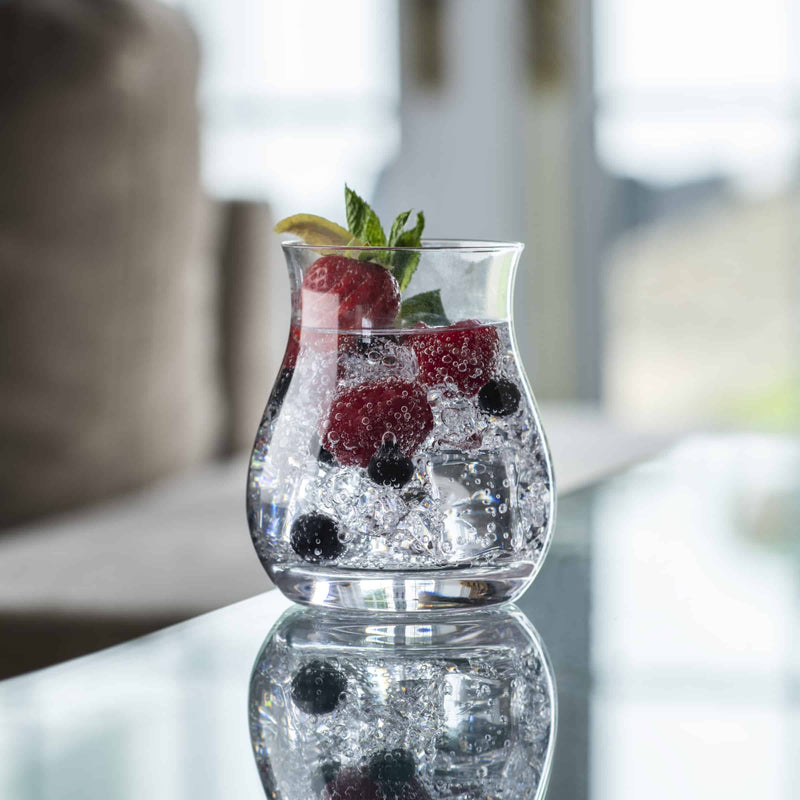 Glencairn Canadian whisky glass holding a drink with fruit and ice