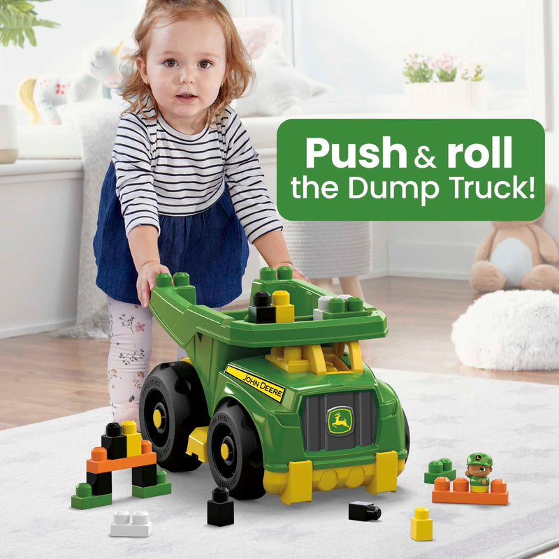 MEGA BLOKS John Deere Dump Truck Building Set (DBL30) — child pushing dump truck