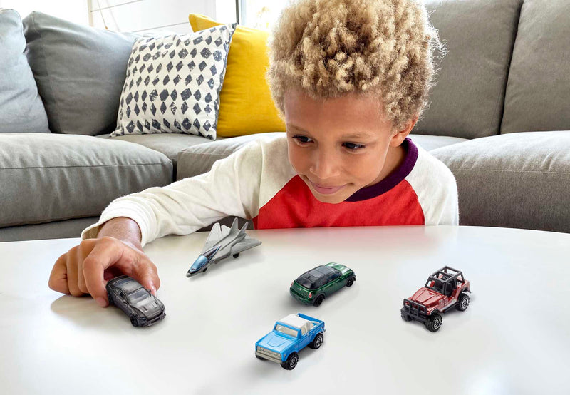 Matchbox - Die-Cast Cars & Trucks (5-Pack, Single Random Pick) — Lifestyle example: child playing with vehicles