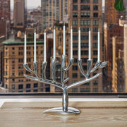 Nambé Tree of Life Menorah in a display setting; other items shown are sold separately.