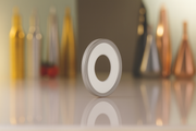 Olipac Dropsafe bottle collar, stainless steel and silicone ring, with bottles in the background